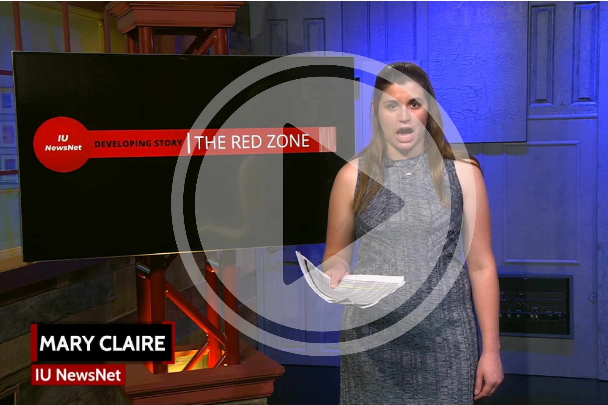 Mary Claire Molloy reporting from the Beckley Studio in front of a screen that says "IU NewsNet Developing Story: The Red Zone."