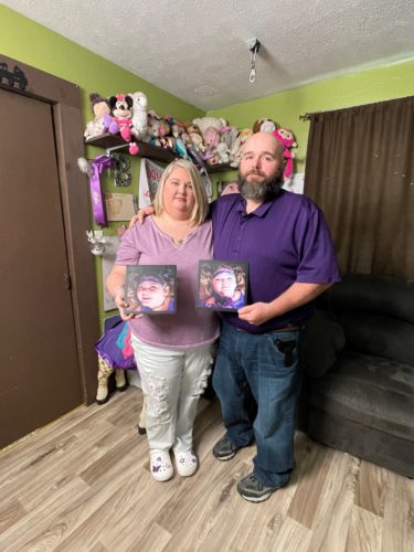 Sarah and Keith Streeval stand in front of a memorial to their daughter, Bella, who died in 2020 from the rare disorder.(Joce Sterman, InvestigateTV)