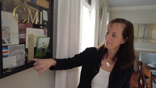 Mary Hummer points out details on a commemorative display made in honor of her brother, Charlie Lykins, who was killed in the 2006 crash of a Comair regional jet. Source: InvestigateTV
