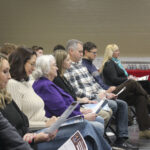 Boone County residents read a list of priorities from their local legislators at the Boone County Legislative Breakfast at the Boone County Fairgrounds on Feb. 1, 2025. (Mia Hilkowitz/Arnolt Center for Investigative Journalism)