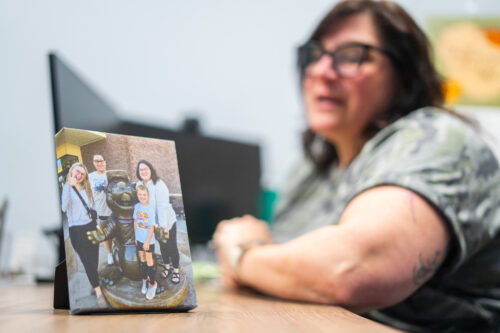 A canvas photo from a family vacation is seen on Emily Meyer’s desk March 27, 2025, in her office at the Dubois County Community Corrections Center in Jasper, Indiana. This was the only vacation Meyer had taken with her children. (Photo by Alayna Wilkening)