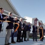 Indiana Gov. Mike Braun (fifth from left) and stakeholders celebrate the ribbon cutting of The District Phase II, a workforce housing development in Princeton, Indiana, on Jan. 12, 2026. The READI 2.0-funded expansion adds 114 new housing units. (Photo from Braun’s official Flickr)