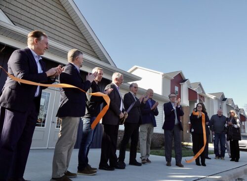 Indiana Gov. Mike Braun (fifth from left) and stakeholders celebrate the ribbon cutting of The District Phase II, a workforce housing development in Princeton, Indiana, on Jan. 12, 2026. The READI 2.0-funded expansion adds 114 new housing units. (Photo from Braun’s official Flickr)