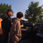 Federal agents take a 19-year-old man into custody after a traffic stop in Avon. (Photo from Avon bodycam footage)