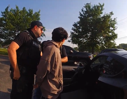 Federal agents take a 19-year-old man into custody after a traffic stop in Avon. (Photo from Avon bodycam footage)