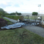 The wreckage of the small plane after it crashed into Bishops car and ultimately impacted a perimeter fence of the airport. NTSB Photo