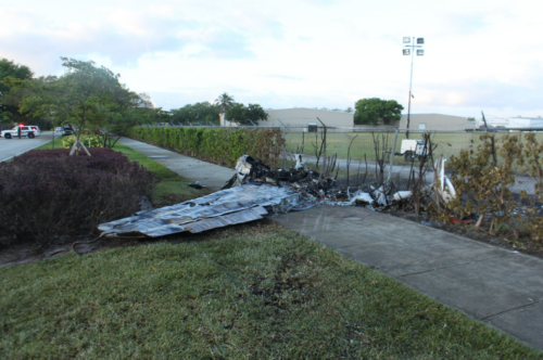 The wreckage of the small plane after it crashed into Bishops car and ultimately impacted a perimeter fence of the airport. NTSB Photo