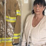 Whistleblower Diane Cotter stands with the turnout gear her husband wore that kicked off a decade-long advocacy effort to raise awareness about the PFAS contained in firefighter protective equipment.