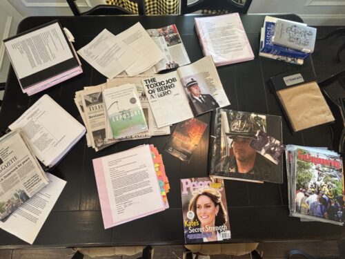 The kitchen table at the home of Paul and Diane Cotter is covered in media articles about their advocacy as well as color-coded binders containing documents related to PFAS in turnout gear that Diane has been amassing for years.
